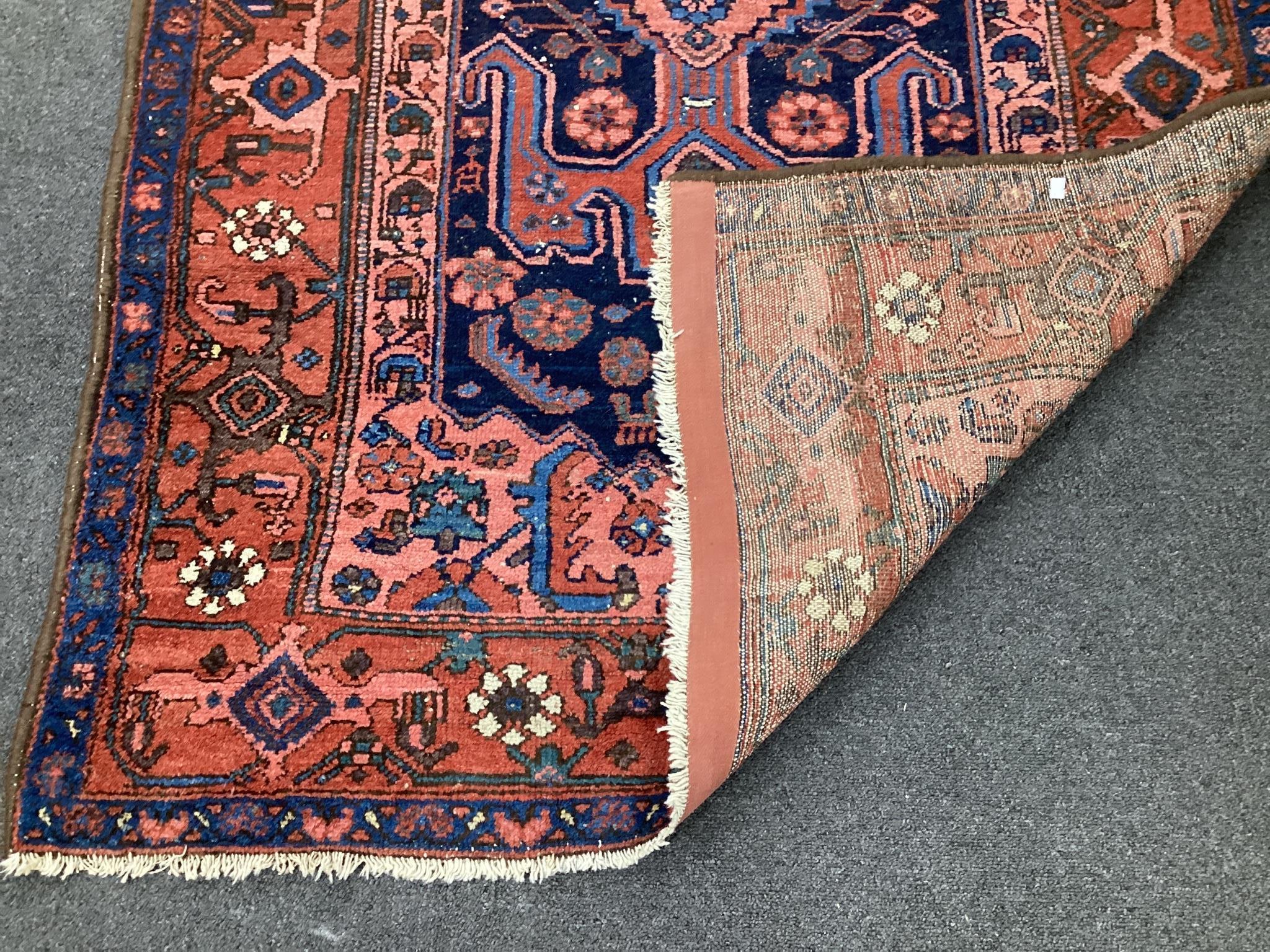 A Kurdish blue ground rug, 186 x 114cm